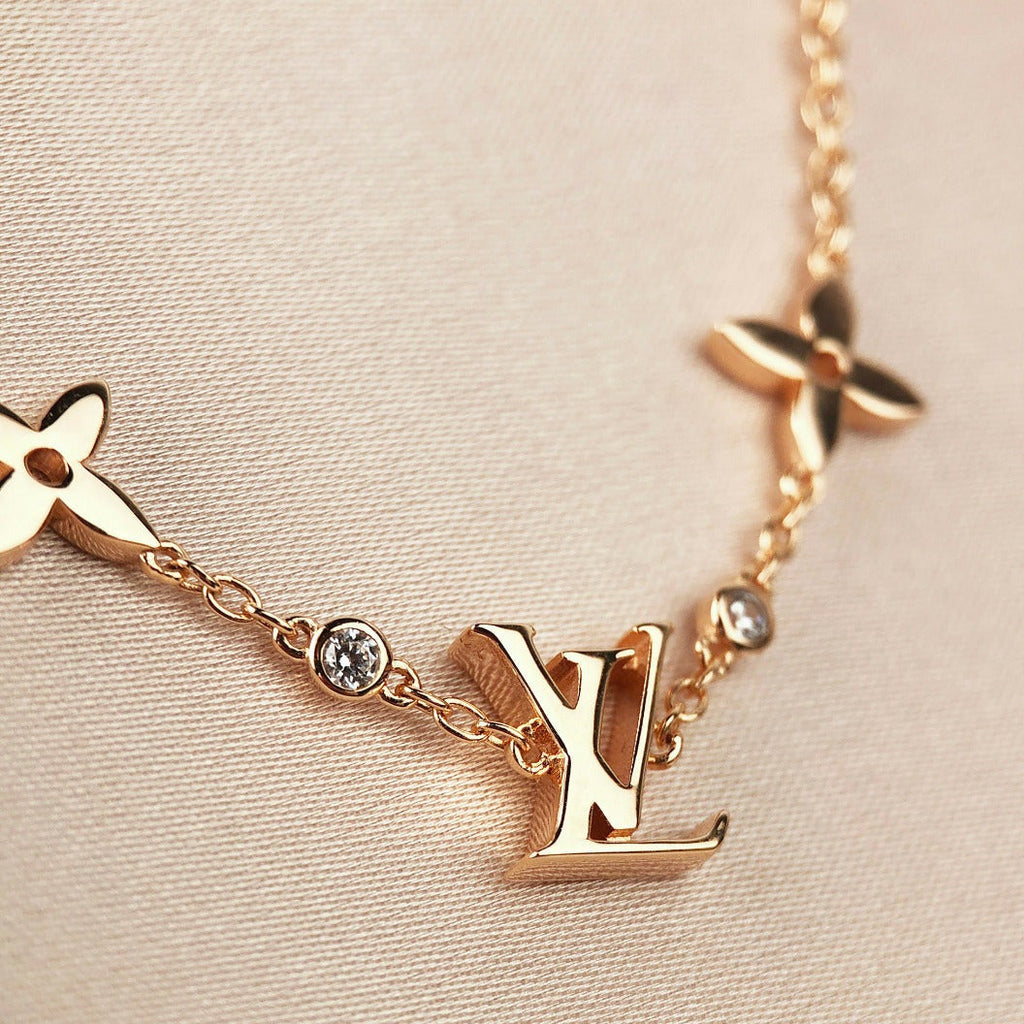 „Dream“-Armband mit Stern-, Sonnen- und 7 Motiven in Gold