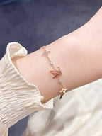 „Dream“-Armband mit Stern-, Sonnen- und 7 Motiven in Gold