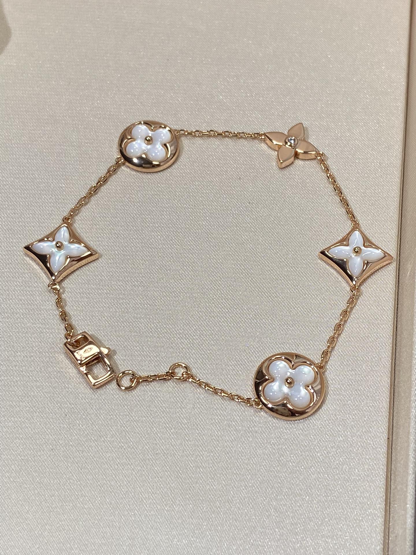 Armband mit 5 Motiven aus Perlmutt, Gold und Sterlingsilber, besetzt mit rosa Zirkonia im Traumstern- und Sonnen-Design